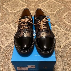 New John Fluevog Guardian Angel Classic Toe Capp in black and jacquard print.